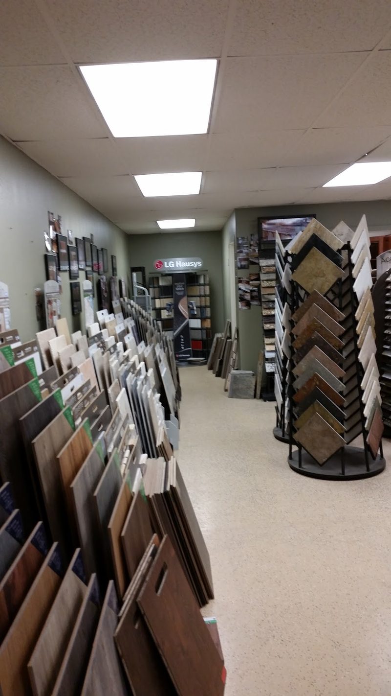 Swing-arm display stands holding flooring and countertop samples inside the showroom.